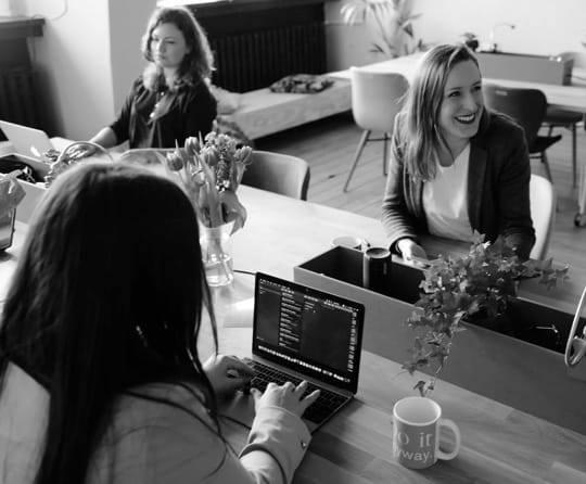 Happy looking business women working in an office environment